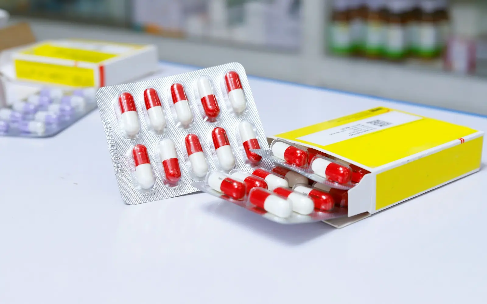 A capsule blister pack beside its printed carton